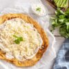hungarian traditional langos with garlic, cream, and cheese